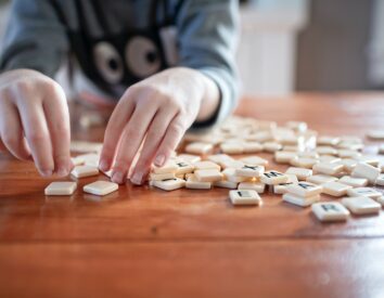 Hands touching Scrabble tiles